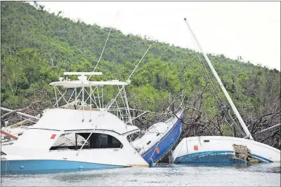  ?? RODRIGUEZ/THE NEW YORK TIMES PHOTOS] [ERIKA P. ?? Boats damaged by hurricanes can still be seen at Coral Harbor on St. John in the U.S. Virgin Islands.