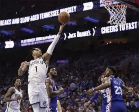  ?? CHRIS SZAGOLA – THE ASSOCIATED PRESS ?? Brooklyn scorer D’Angelo Russell, left, doing just that over Joel Embiid in Game 1 last Saturday, will have to be challenged in Game 3 if the Sixers hope to take an edge in the first-round series.