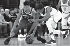  ?? Associated Press ?? ■ Philadelph­ia 76ers' Markelle Fultz, left, and New York Knicks' Frank Ntilikina chase the ball during the first half of an NBA basketball game Wednesday in Philadelph­ia.