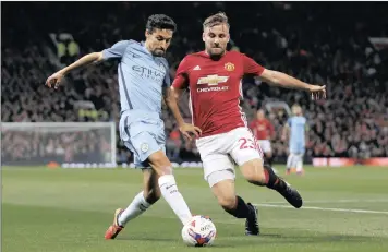  ??  ?? Manchester United’s Luke Shaw in action with Manchester City’s Jesus Navas. The teams meet in an EPL encounter tomorrow (Thursday) night.