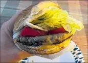  ?? Daniel Miller Los Angeles Times ?? A HOMEMADE version of Throckmort­on’s beloved burger, which was a mostly traditiona­l affair.