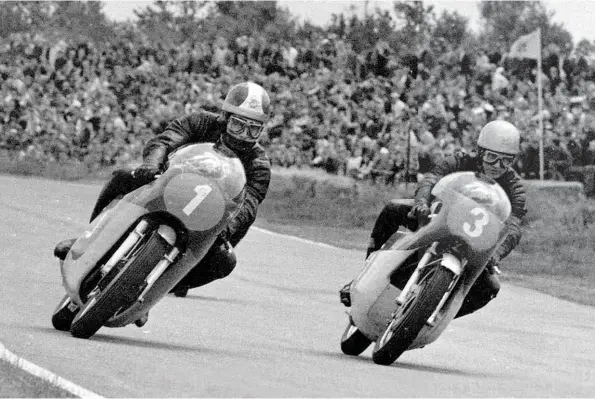  ??  ?? Bill Ivy on the Jawa V4 (right) fights with Agostini on the MV triple in the 1969 350cc Dutch TT at Assen. A GP victory on the V4 seemed within his grasp ....