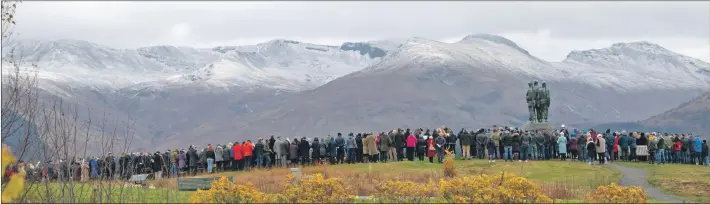  ??  ?? Above, a large crowd braved the cold weather to pay tribute at the Commando Memorial.