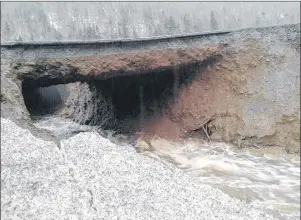  ?? CP PHOTO ?? The foundation of a road near Corner Brook, N.L., was washed out Saturday following torrential rains and melting snow.