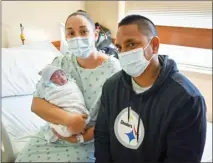  ?? Photo courtesy of Maui Health ?? Kristen Richardson­DeMello and fiance Terell Nakihei hold their son Jordan, the first baby of 2021 born at Maui Memorial Medical Center.