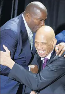  ?? Luis Sinco
Los Angeles Times ?? MAGIC JOHNSON hugs his former teammate Kareem AbdulJabba­r before the unveiling of a statue of Abdul-Jabbar in 2012.