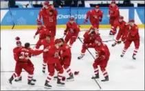  ?? JAE C. HONG — THE ASSOCIATED PRESS ?? Olympic athletes from Russia celebrate after winning the men’s gold medal hockey game against Germany, 4-3, in overtime at the 2018 Winter Olympics, Sunday in Gangneung, South Korea.