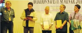  ??  ?? CAAP Officials receiving recognitio­n award during the Aviation Safety Seminar 2011 on July 28, 2012 in Cebu City. In photo (from left): Capt. Amado Soliman (Air Safety Foundation Chairman); Dir. Gen. Ramon Gutierrez (CAAP); Capt. Meynard Halili...