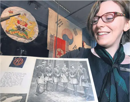  ?? Picture: Phil Hannah. ?? Museum curator Hope Busak with one of the albums donated to the museum.