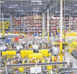  ?? STAFF FILE PHOTOS BY ROBIN RUDD ?? The huge Amazon fulfillmen­t center processes orders in the Enterprise South facility. Amazon has taken steps to combat the coronaviru­s and safeguard the health of the workers at their CHA1 fulfillmen­t center.