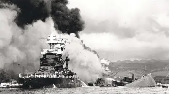  ?? AP FILE PHOTO ?? Part of the hull of the capsized USS Oklahoma is seen at right as the battleship USS West Virginia (center) begins to sink after suffering heavy damage, while the USS Maryland (left) is still afloat in Pearl Harbor, Oahu, Hawaii after Japan attacked Dec. 7, 1941.