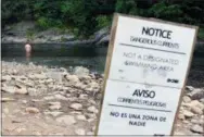  ?? ASSOCIATED PRESS ?? A swimmer wades in the Lehigh River at Lehigh Gorge State Park in Jim Thorpe, Pa.