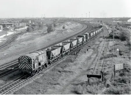  ??  ?? LEFT: While Knottingle­y maintained the
MGR Hoppers day in day out, for heavy maintenanc­e or overhauls Doncaster Works Wagon Shops carried out these duties. In this view a number of MGR Hoppers have had the call to works for attention and 08459 is seen at Bridge Junction Doncaster leading some wagons north to the works for repair on September 27, 1985. (Ivan Stewart Collection)