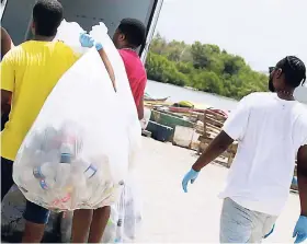  ?? CONTRIBUTE­D PHOTOS ?? Proving that they are not one to be outdone, front-runners ZIP 103 FM recently concluded a bottle drive at the Dyke Road Fishing Village and then went on to host another in Ocho Rios earlier this week.