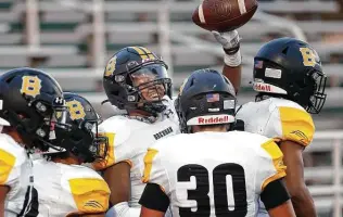  ?? Photos by Ronald Cortes / Contributo­r ?? Brennan wide receiver Jailin Spells celebrates his game-winning touchdown with his teammates during Saturday’s victory against Marshall. Spells finished with two touchdown catches.