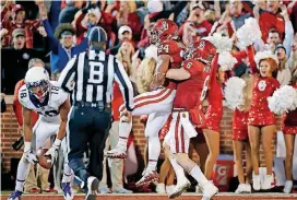  ?? [PHOTO BY BRYAN TERRY, THE OKLAHOMAN] ?? Baker Mayfield, right, celebrates with Rodney Anderson after Anderson’s touchdown against TCU.