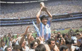  ?? Carlo Fumagalli / Associated Press 1986 ?? Diego Maradona hoists the World Cup trophy after Argentina beat Germany 32 in the final at Mexico City’s Azteca Stadium.