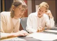  ?? CHRISTOPHE­R BOYES/UNIVERSITY OF MICHIGAN ?? Professor Patricia Hall and graduate student Josh Devries review a music manuscript on campus in Ann Arbor, Mich.