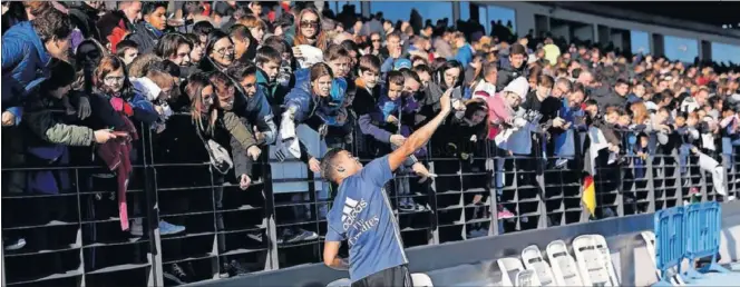  ??  ?? CARIÑO PARA LA AFICIÓN. Mariano quiso hacerse un ‘selfie’ con los aficionado­s después de regalarles los balones.