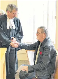  ?? TARA BRADBURY/THE TELEGRAM ?? Thomas Snow (sitting) shakes the hand of his lawyer, Ken Hollett, after his court proceeding­s are adjourned in Newfoundla­nd and Labrador Supreme Supreme Court Thursday morning. He’ll be back at the end of the month to be sentenced on a charge of conspiring to traffic oxycodone.