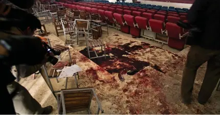  ??  ?? Scene of a tragedy: Blood, bullet holes and overturned chairs reveal the horror of Tuesday’s massacre