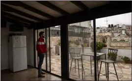  ?? ?? Rony Fakhouri manages a Bethlehem guesthouse that is struggling because the war in Gaza has led to a steep drop in visitors. The symbolism of Christmas is part of the soul of the city, but the war has cast a pall.