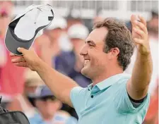  ?? Charlie Neibergall/Associated Press ?? Scottie Scheffler celebrates winning The Players Championsh­ip by a margin as wide as his arms are spread.