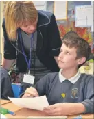  ?? FM2584894 ?? Head teacher Ashley Crittenden chats with Luke in Willow class at West Borough Primary School