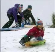  ?? MIC SMITH — THE ASSOCIATED PRESS ?? Children sled down a hill on a golf course at the Isle of Palms, S.C., Wednesday.