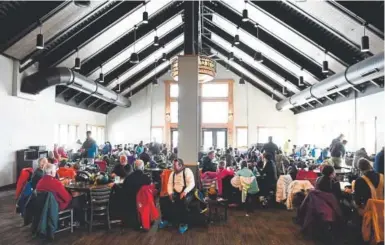  ?? Andy Cross, The Denver Post ?? Skiers and snowboarde­rs enjoy lunch last week at the Lunch Rock Restaurant ski lodge high atop the Mary Jane Territory at the Winter Park Resort.