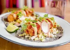  ?? Michael Short/Special to the Chronicle ?? The tacos de pescado from La Calenda. The color of the tortillas changes regularly at the Yountville restaurant.