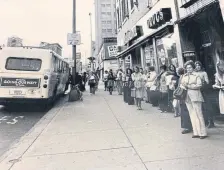  ?? Provided by Regional Transporta­tion District ?? Pedestrian­s stand near a Regional Transporta­tion District bus in this undated file photo.