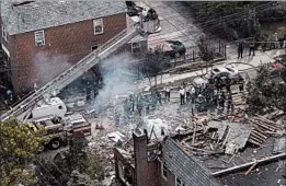  ?? MARY ALTAFFER/AP ?? Debris litters the scene Tuesday after a home explosion in the Bronx borough of New York City. Michael Fahy, a 17-year fire department veteran and father of three, was killed.