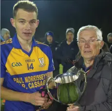  ??  ?? Seán Ryan of Gusserane receives the John Hayes Memorial Cup from Michael Bowe, New Ross District Chairman.