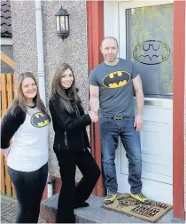  ??  ?? Batcave door Claire Aitchinson of Caledonian Windows with Leanne Cameron and Steve Smith of Patna outside their new Batman door