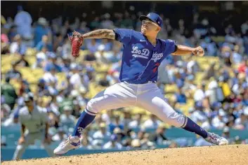  ?? Photograph­s by Gina Ferazzi Los Angeles Times ?? JULIO URÍAS struck out eight of the final nine batters he faced to lead the streaking Dodgers to an 8-3 victory over the Colorado Rockies at Dodger Stadium. The NL West leaders have 12 wins in 13 games in August.