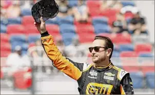  ?? Ralph Freso / Associated Press ?? Kurt Busch, waving to fans during driver introducti­ons prior to the NASCAR Cup Series race last year at Phoenix Raceway, posted the fastest practice time on Saturday as NASCAR’S Cup Series returned to Road America for the first time since 1956. Busch’s contract is up at the end of the season and owner Chip Ganassi sold his team last week, leaving Busch’s future in limbo.