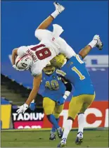  ?? KEITH BIRMINGHAM — STAFF PHOTOGRAPH­ER ?? Stanford wide receiver Brycen Tremayne catches a pass and is upended by UCLA’s Jay Shaw.