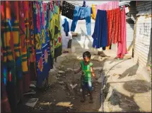  ?? ?? A child plays with a jump rope July 19 in a narrow lane of a poor neighborho­od in Bengaluru, India.