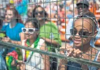  ??  ?? Thousands flocked to watch the parade Saturday as it passed the Exhibition grounds on Lake Shore Blvd.