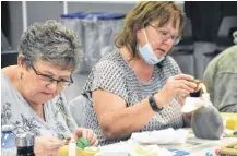  ?? TINA COMEAU ?? Ukrainian Pysanky egg Digby workshop participan­ts Barb King and Phyllis Harlow gingerly work on their design creations, while thankful for the opportunit­y to show their support for the people of Ukraine.