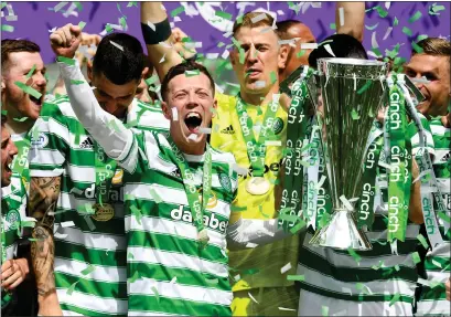  ?? ?? Callum McGregor and his team-mates celebrate after Celtic sealed the Premiershi­p title