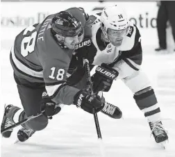  ?? AP ?? The Jets’ Bryan Little (18) and the Coyotes’ Christian Fischer fight for position on Saturday in Winnipeg, Manitoba.