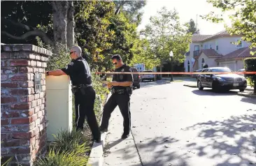  ?? GARY REYES/STAFF PHOTOS ?? San Jose police officers investigat­e the scene of a fatal double shooting. A mentally ill man apparently killed the parents of his ex-girlfriend and held her brother hostage in a bid for revenge after she broke up with him.