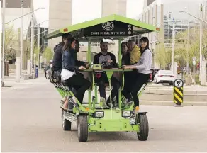  ?? GREG SOUTHAM ?? Matt Gosse takes people on a test outing Friday with one of two 15-passenger bikes that will be appearing around the city soon.