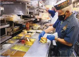  ?? ADOLPHE PIERRE-LOUIS/ JOURNAL ?? Frontier General Manager Pete Villegas makes a chicken fiesta sandwich May 17.