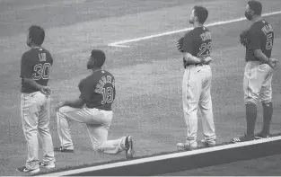  ??  ?? The Red Sox’s Jackie Bradley Jr., second from left, kneels during the national anthem before a game against the Mets on July 29 in New York.