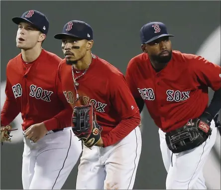  ?? MICHAEL DWYER - THE ASSOCIATED PRESS ?? FILE - In this Friday, April, 12, 2019 file photo, Boston Red Sox’s Andrew Benintendi, left, Mookie Betts, center, and Jackie Bradley Jr. run in after defeating the Baltimore Orioles during a baseball game in Boston.