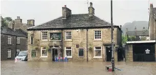  ??  ?? The stricken Cotton Tree pub in July’s flash flooding