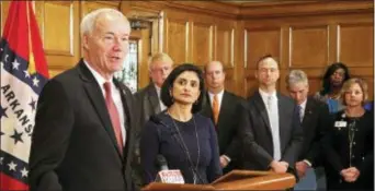  ?? KELLY P. KISSEL — THE ASSOCIATED PRESS ?? Gov. Asa Hutchinson speaks at a news conference Monday at the state Capitol in Little Rock, Ark., with Seema Verma, the head of the Centers for Medicare and Medicaid Services. Verma on Monday approved a state plan to require that thousands of people on...